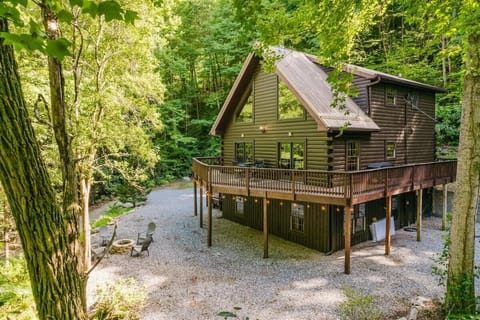 Modern mountain cabin nestled in Bryson City with gravel driveway, wraparound deck, and wooded privacy near Great Smoky Mountains National Park.