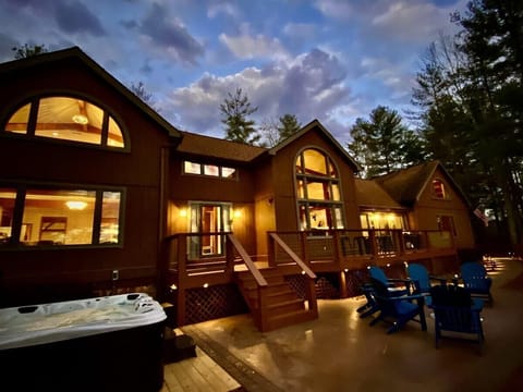 Evening view of Lookout Lodge cabin illuminated with warm lights and mountain backdrop near Bryson City.