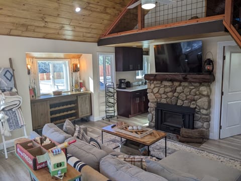 Our main cabin has a bar area for spill over storage, tv, wood burning fire pace and tv with cable and streaming channel capabilities. There are also plenty of blankets for cooler nights on the couch.