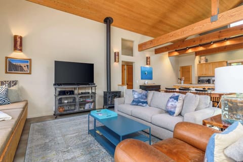 Bright living area with comfy seating and Smart TV