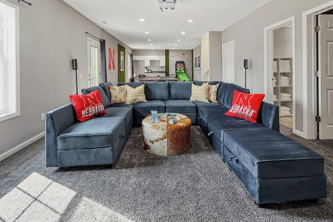 Game room with cozy lounge seating and carpeted flooring