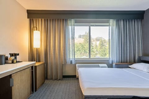 Wake to hillside views and crisp linens in a serene room.