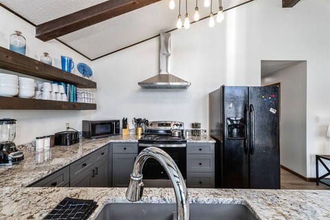 Microwave, Electric Range, Blender, hand mixer, griddle, waffle iron, coffee pot (coffee, creamer, and sugar provided), crock pots, and toaster. 