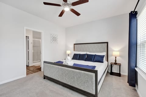 Serene master bedroom with a king-sized bed, closet space and dresser.