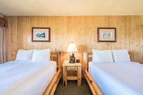 Drift off surrounded by warm wood tones and soft bedside light.