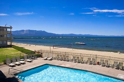 Swim steps from the sand with mountains on the horizon.