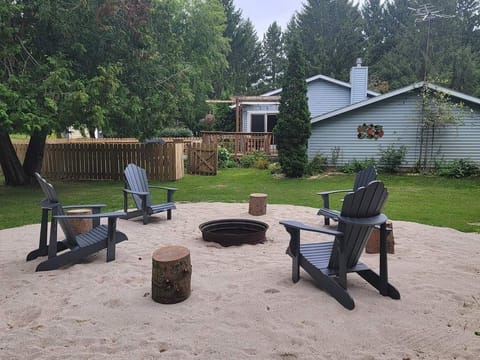 Outdoor firepit area with plenty of firewood.