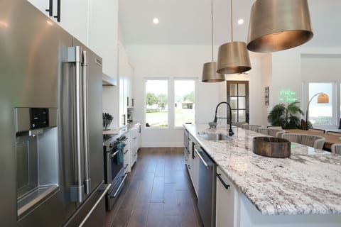 Beautiful kitchen with sleek stainless steel appliances, large island, and ample natural light.