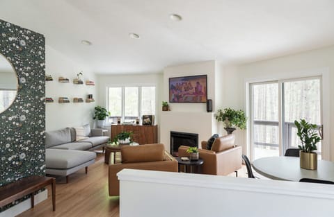 Large living space on second floor with smaller dining table. 