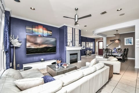 Chic Comfort: Lounge in Style with Blue Hues and Entertainment.