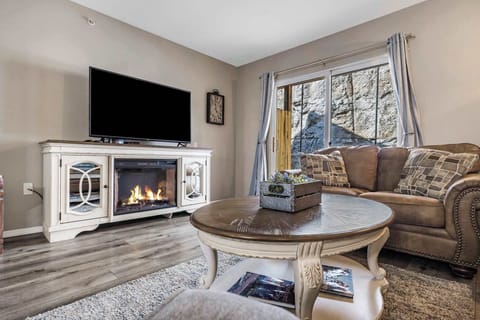 Cozy and spacious living area with TV and fireplace
