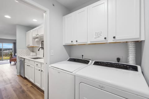 Private laundry is available for your stay, tucked away off the kitchen