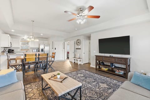 Open living space with Queen sofa sleeper, TV, and deck access