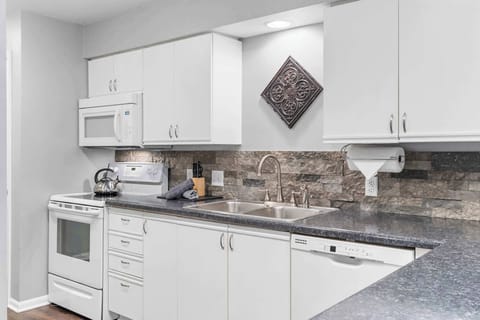 The airy, open kitchen is fully equipped with all the comforts of home