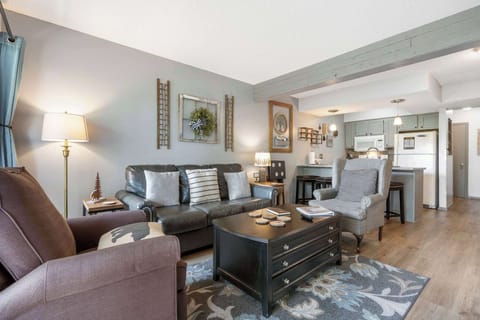 Open living space with Queen sofa sleeper, TV, and deck access