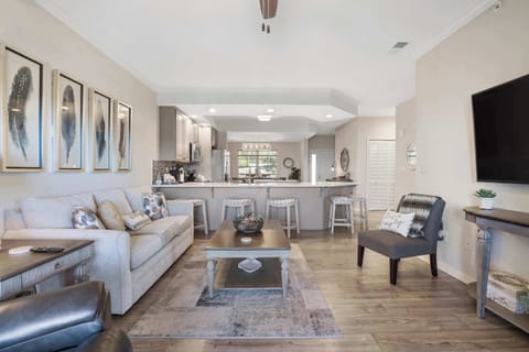 Open living space with Smart TV, sofa sleeper, balcony & sunroom access