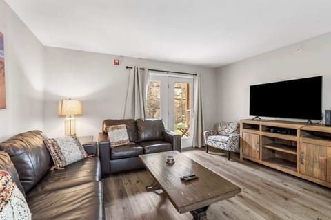 Modern spacious living area with TV