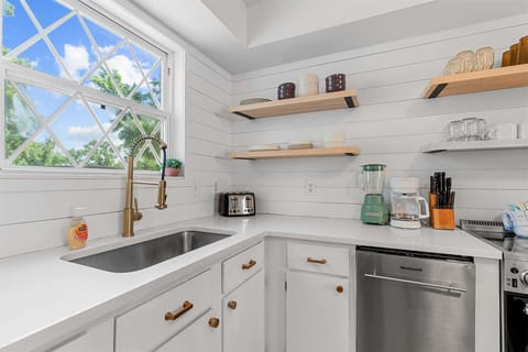 The bright, airy kitchen offers ample space & all the comforts of home
