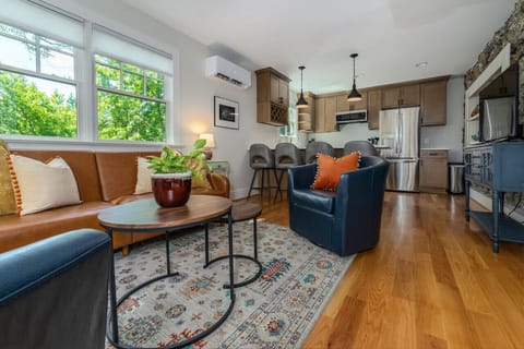 A beautifully integrated living room and kitchen setup. Gather around the peninsula bar, seating four, and enjoy effortless streaming with the Apple TV-equipped Roku TV