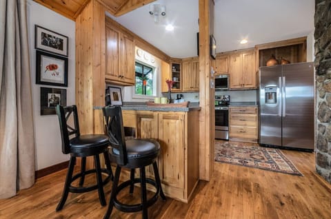 Fully stocked kitchen with two bar seats overlooking the dining area. All you need are your groceries!