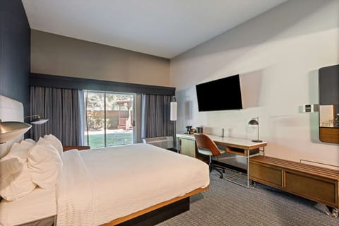Settle in with a roomy layout, desk, and big-screen TV.
