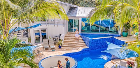 Waterfront masterpiece with its ship-like, nautical-inspired design. The open-concept living, dining, and chef's kitchen are bathed in light from a grand window, framing Fort Lauderdale's skyline and tranquil canal.