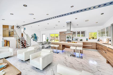 The open-concept living, dining, and chef's kitchen offers an inviting space for guests to gather and enjoy at ease.