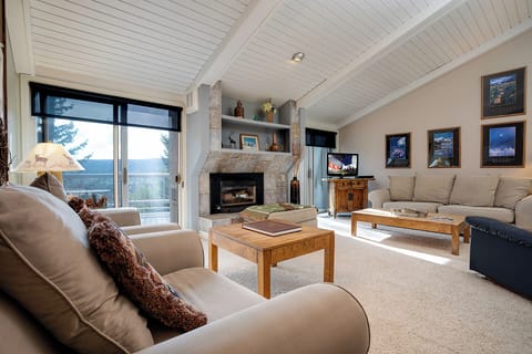 Sink into plush sofas by your cozy fireplace while natural light streams through floor-to-ceiling windows.