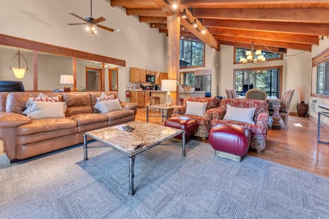 Living Room: Leather couch, 2 club chairs, dedicated workspace, 46” TV, wood-burning fireplace, patio access 