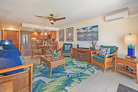 The spacious living area at Kahana Sunset B4B features tropical accents and an open flow to the kitchen and dining spaces.
