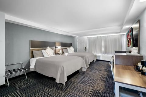 Unwind in a spacious double-queen room with cozy comforts.