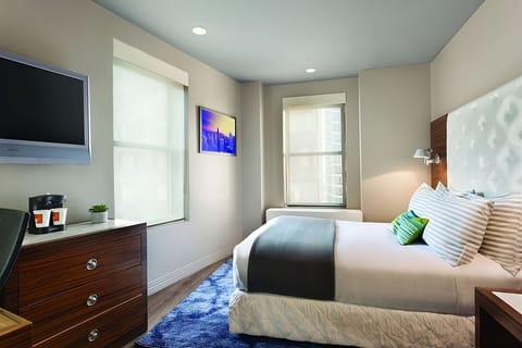 Stretch out on crisp linens in a calm, modern room.