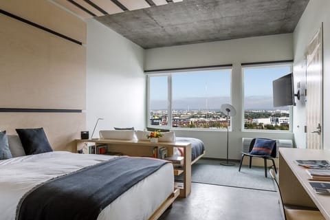 Wake up to sweeping skyline views from a serene bed.