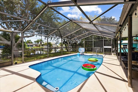Screen-enclosed private pool with  stunning canal views for the ultimate retreat!