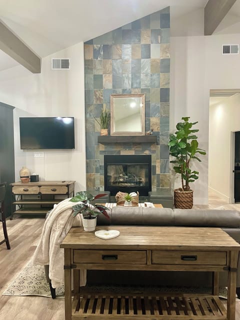 Cozy living room has a huge slate gas fireplace and swivel TV