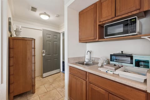 - Compact kitchenette with microwave, sink, and counter space for easy meal prep  
- Convenient storage cabinets to keep everything organized during your stay  
- Perfect setup for quick snacks or morning coffee before exploring the area  
