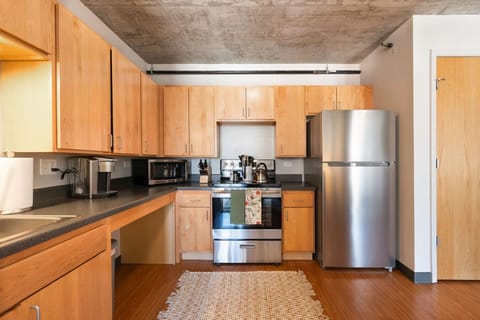 Fully equipped modern kitchen with stainless steel appliances and ample counter space.