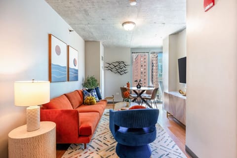 Bright, stylish apartment with a cozy living area, city views, and a peaceful bedroom retreat