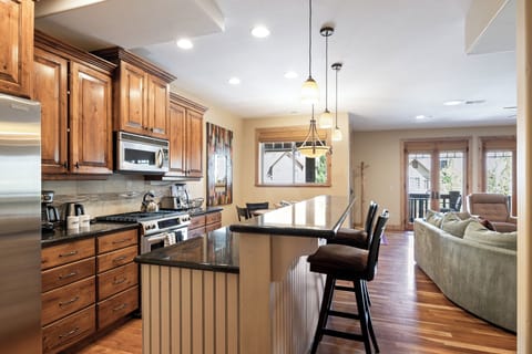 - Cook with ease in a chef-friendly mountain kitchen  
- Granite counters and wood cabinetry for style  
- Open design flows to living room and dining areas