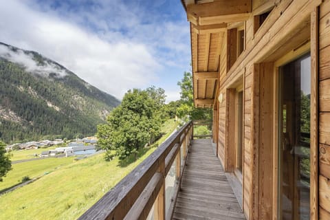 Step out onto the spacious wooden balcony and take in the breathtaking views of the surrounding mountains.