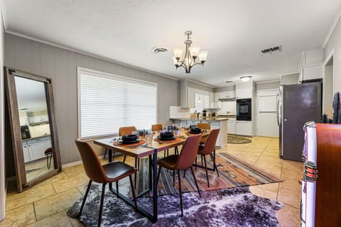 Dining area with 6 seats; nearby kitchen