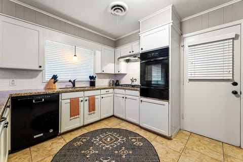 The kitchen is equipped with a window with blinds