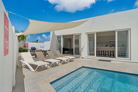 - Relax on stylish lounge chairs by the private pool, perfect for sunbathing - Enjoy seamless indoor-outdoor living with sliding doors, open to a modern kitchen - Host the perfect outdoor gathering with a BBQ grill and spacious al fresco dining setup
