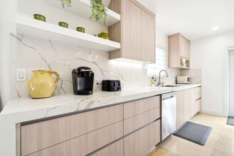 With a functional layout, a center kitchen island, and a plethora of kitchen appliances, this custom-made kitchen has everything you need to unleash your culinary creativity.