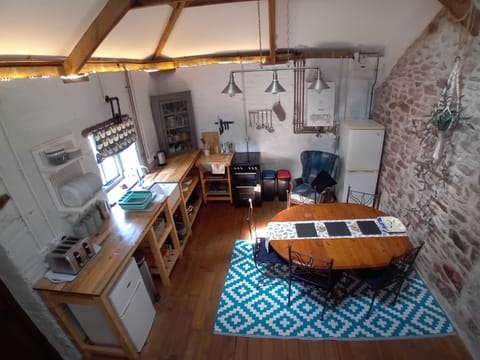 Kitchen/dining area. Fridge/freezers, oven/hob/grill, dishes and cutlery.