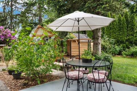 outdoor apartment patio overlooking the gardens, birds and rustic backyard spa