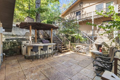 Enjoy outdoor dining and cozy fireside evenings in this charming patio, complete with a bar and fireplace.