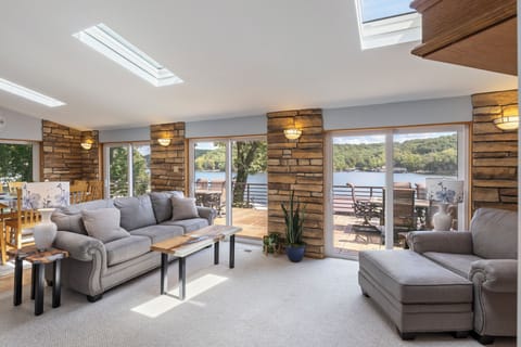 Bright and cozy living area with stunning lake views from every corner—your perfect spot to relax and recharge.