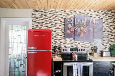 Kitchen in Apt 1: Bright and stylish with a retro red fridge and vibrant decor for culinary adventures!
