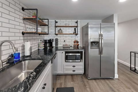 The full kitchen has a dishwasher, microwave, toaster, fridge and stove.